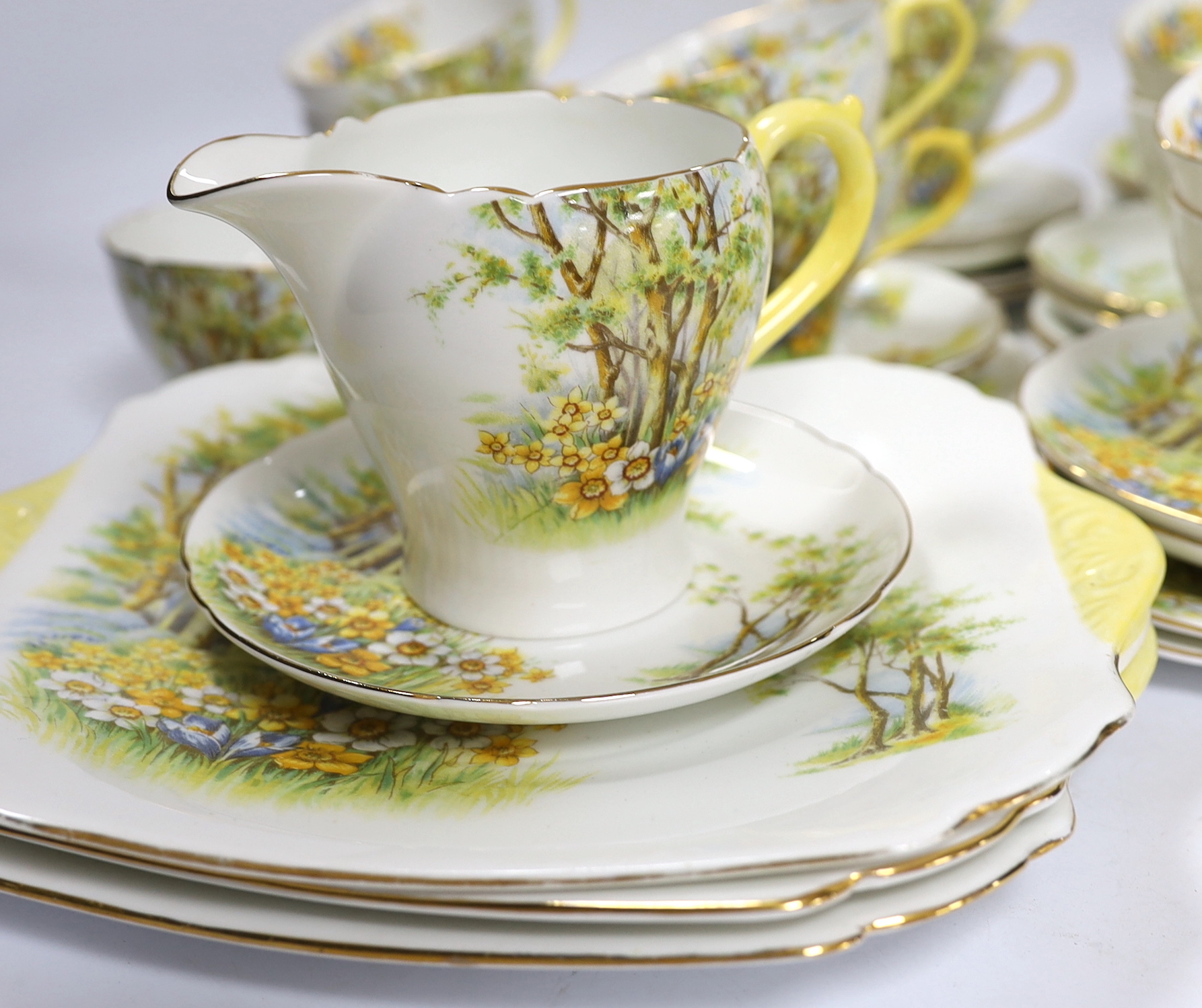 A Shelley ‘Daffodil Time’ pattern tea set with thirteen trios, three sandwich plates, milk jug and bowl, largest 24cm wide